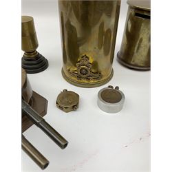 Quantity of brass trench art to include a WWI shell case in the form of a miniature coal scuttle with a Royal Artillery cap badge mounted to the body, three trench art lighters, 1980 Falkland ash tray, cased clock etc