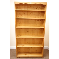  Pine open bookcase, moulded top, four shelves, solid end supports (W89cm, H181cm, D32cm) and another similar bookcase (W90cm, H178cm, D22cm) (2)  