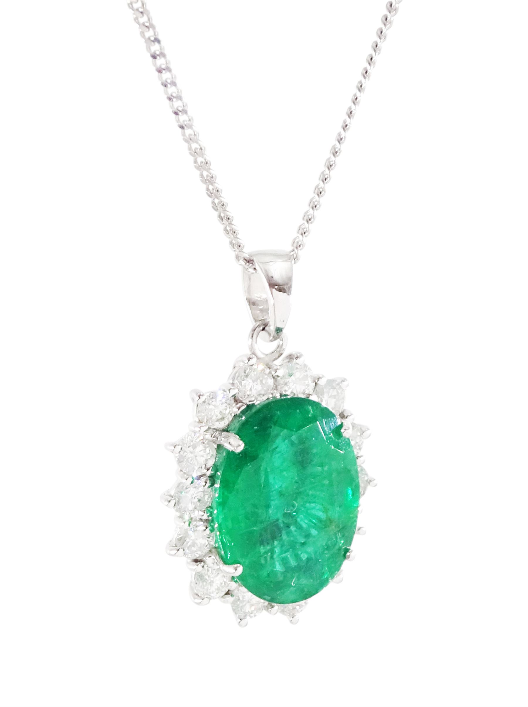 18ct white gold emerald and diamond pendant necklace, single oval cut  emerald of approx 3.25 carat, surrounded by fourteen round brilliant cut diamonds, on a fine link chain necklace, hallmarked, total diamond weight approx 0.50 carat