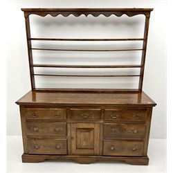 18th century style country elm dresser, raised two tier plate rack above seven drawers and single cupboard, shaped plinth base 