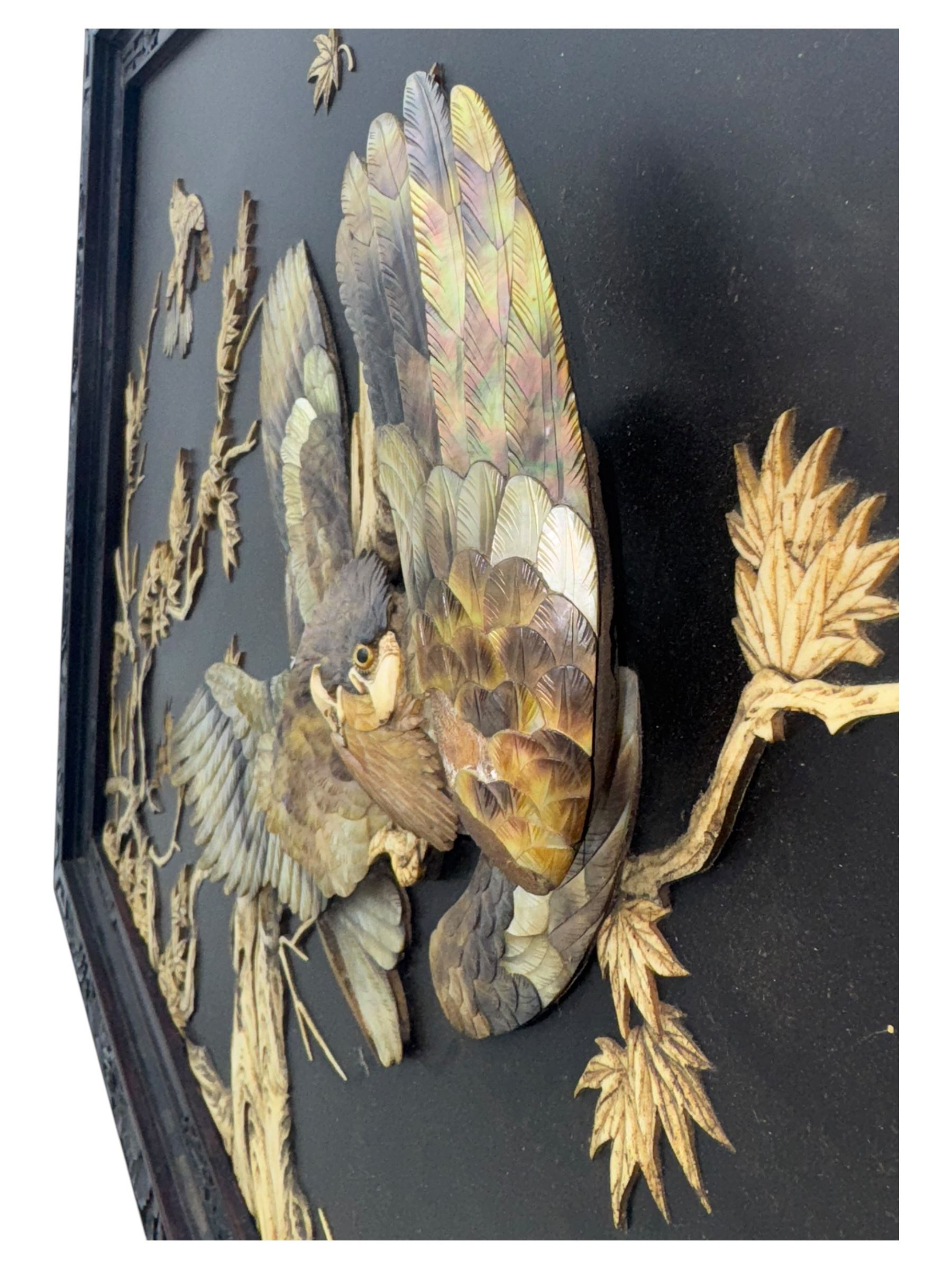 Meiji period (1868–1912), signed Shibayama carved hardwood lacquer panel inlaid with mother-of-pearl and ivory, decorated in high relief and inlaid, depicting two birds of prey with locked talons and beaks on leafy tree branch, signature in lower right corner, in original frame. This item has been registered for sale under section 10 of the APHA Ivory Act