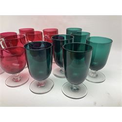 Collection of 19th century coloured glasses, to include nine cranberry glass punch cups, each with clear glass handle and foot and a set of six green glasses, with short clear stems, tallest H10cm