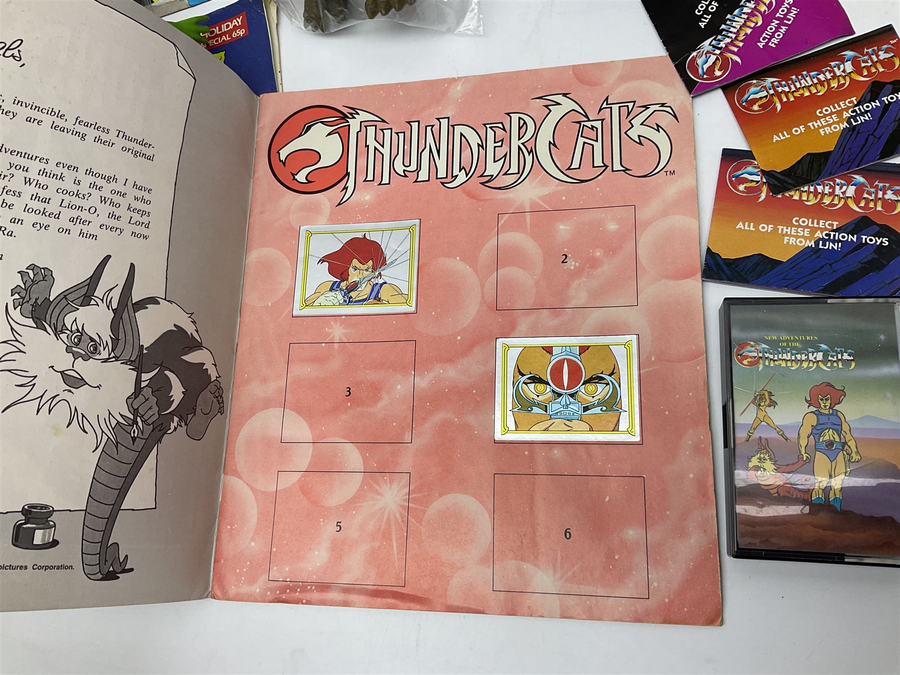 Five 1980s LJN Thundercats figures - Lion-O with sword, Snowman, S-S-Slythe, Tygra and Mumm-Ra; all re-bagged on original backing cards; partially stocked Panini sticker album; story cassette tape and three catalogues; together with Ghostbusters Slimer with food and Comic