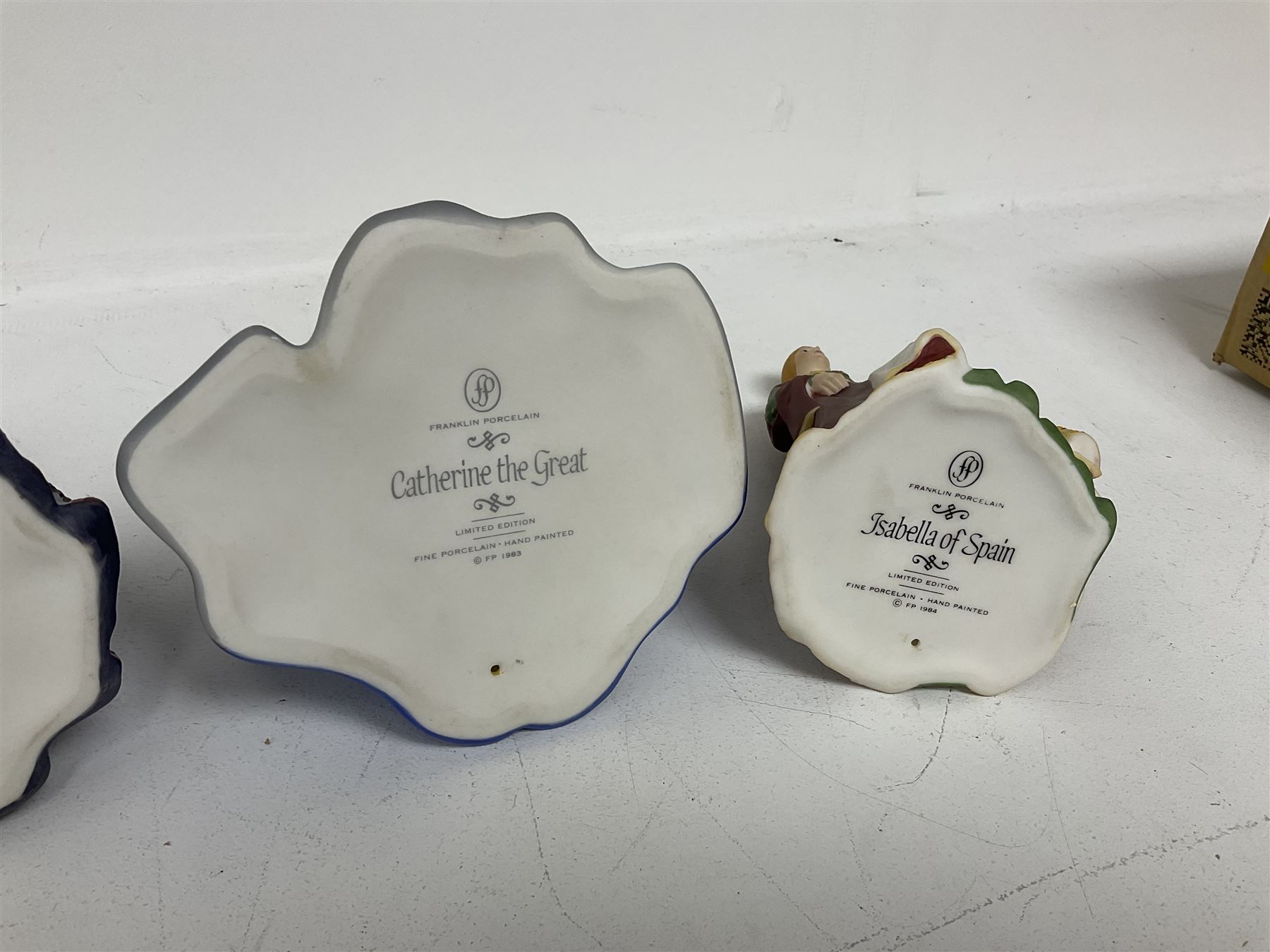 Four limited edition Franklin Mint figures of queens comprising Elizabeth I, Isabella of Spain, Catherine the Great and Marie Antoinette