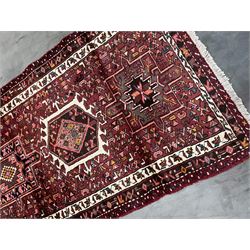 Persian Karajeh runner, red ground field with a series of eleven medallions and profusely decorated with stylised motifs, repeating guarded border