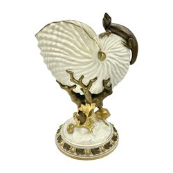 A late 19th Century Royal Worcester vase modelled as a nautilus shell surmounted by a gilt lizard, raised upon a naturalistically modelled gilt coral stem, and spreading base detailed with sea shells and formal shell border to edge, with puce mark beneath with date cypher for 1887, and impressed mark, H22cm

