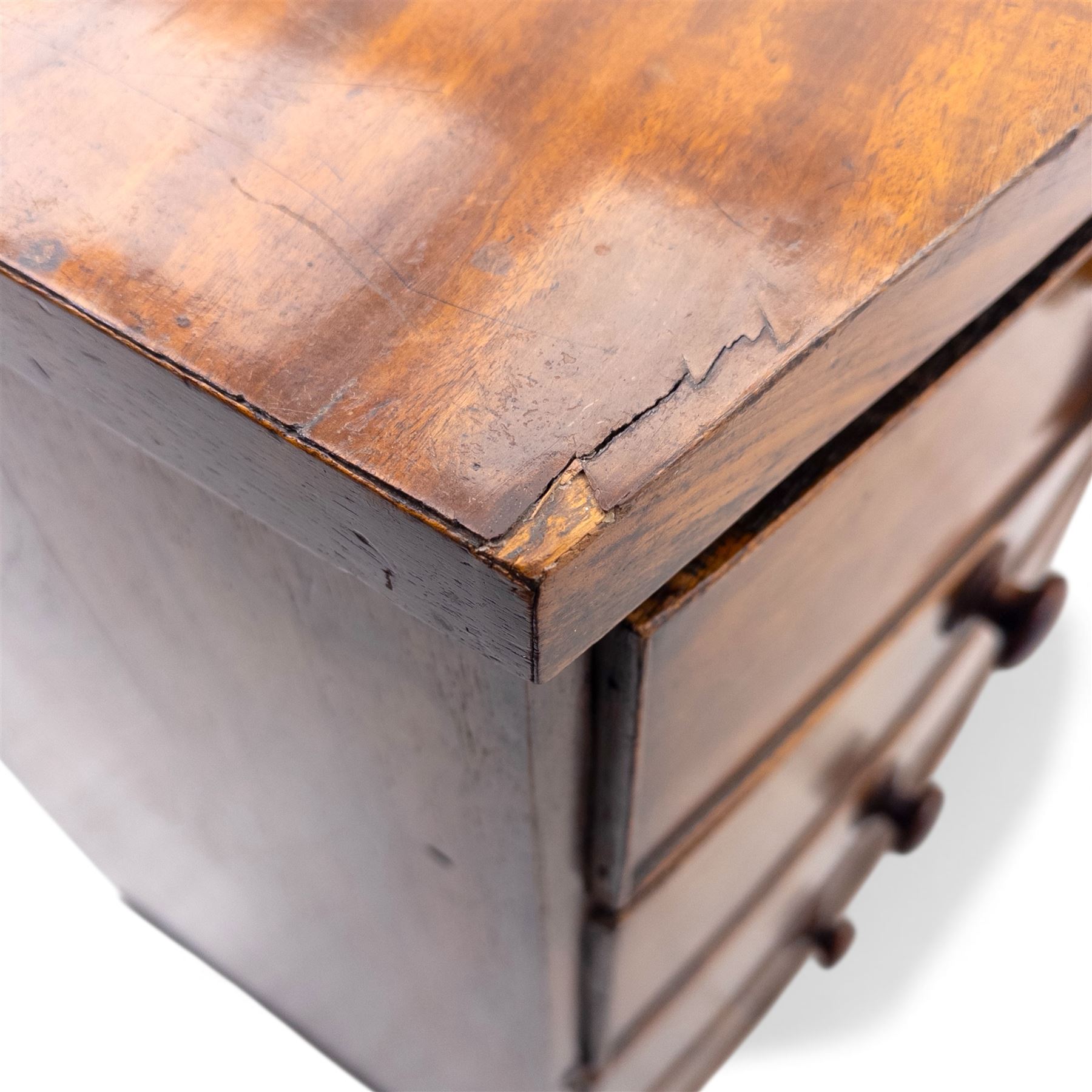 19th century bow front mahogany chest of drawers, rectangular top with moulded edge above an arrangement of two short and three long graduating drawers with turned wooden handles, raised on turned feet