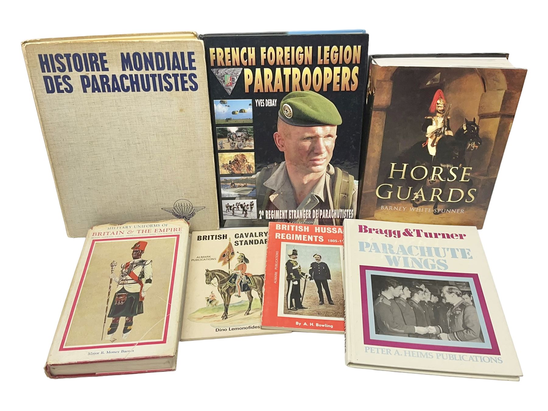 Seven military reference books - Histoire Mondiale Des Parachutistes; Yves Debay: French Foreign Legion  Paratroopers; Bragg & Turner: Parachute Wings; Barney White-Turner: Horse Guards; and three works on uniforms/standards (7)