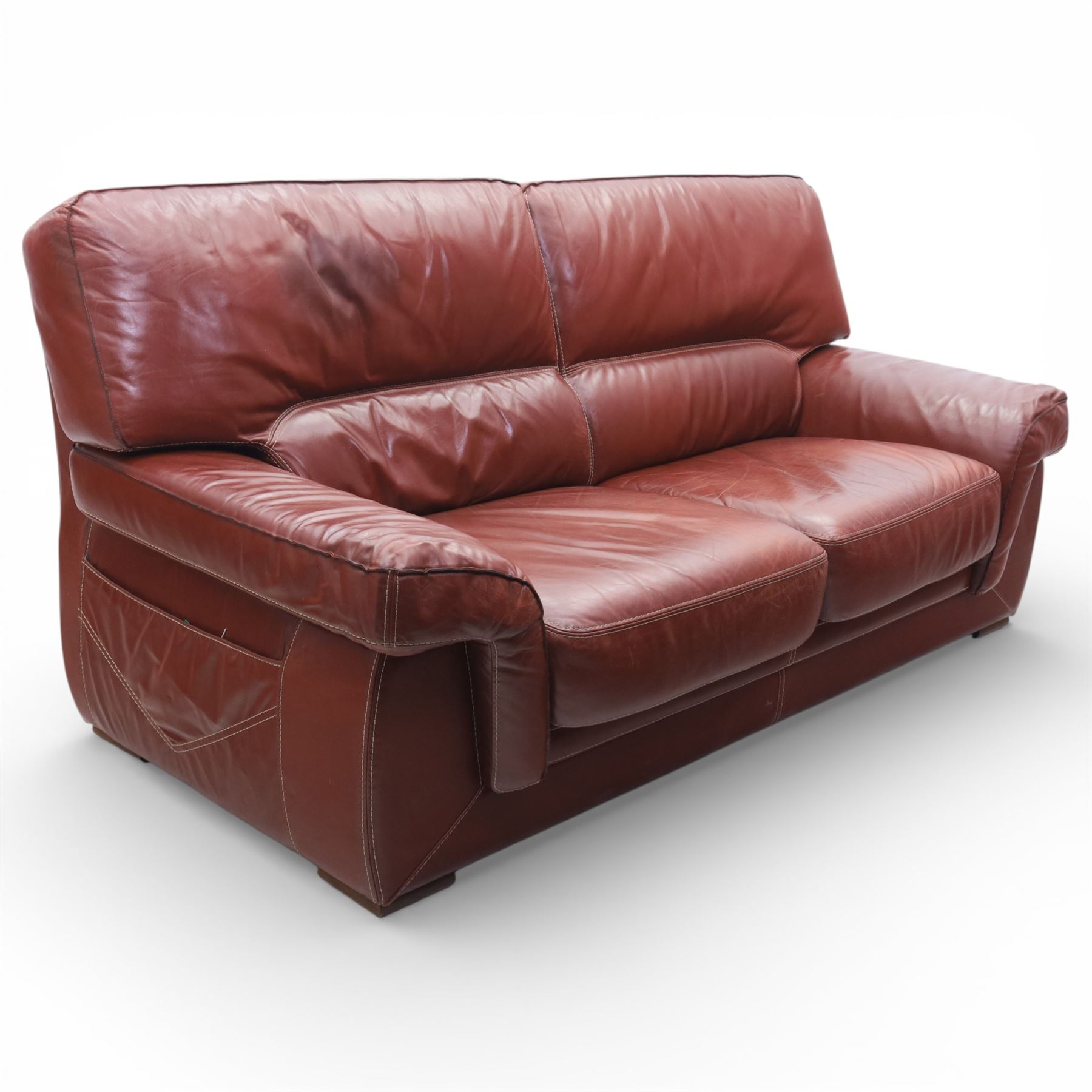 Fabrizio Mantellassi - 20th century Italian red leather suite, one three seat and two large armchairs, upholstered in deep red hide with stitched seam detailing, with magazine pockets to each side, the rectangular back cushions above broad padded arms and seat cushions, raised on low block bases

Sofa: H c98m, W 203cm, D 92cm
Armchair: H 98cm, W 113cm, D 92cm