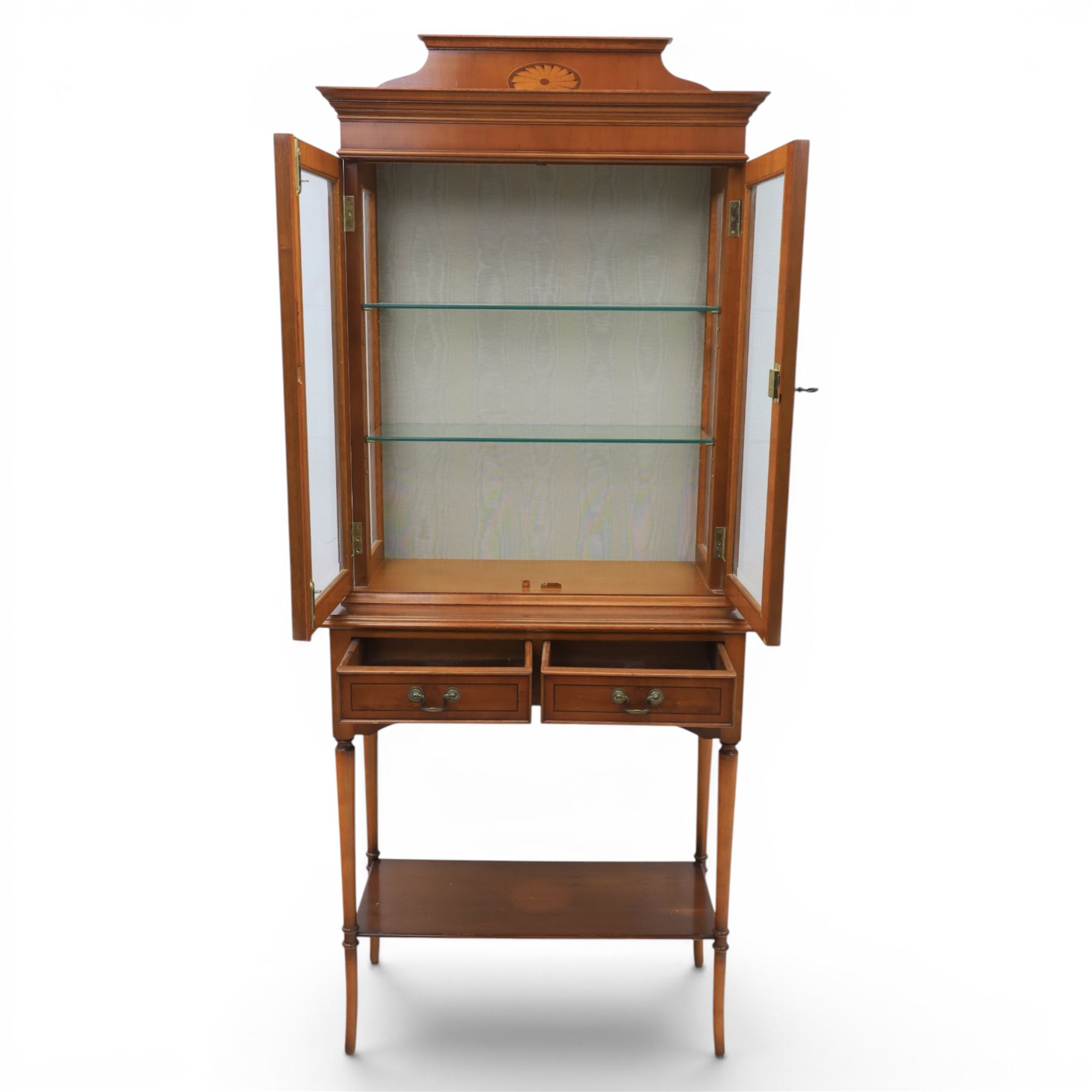 Sheraton design yew wood cabinet on stand, fitted with two glazed doors and two drawers, with lower shelf, illuminated interior