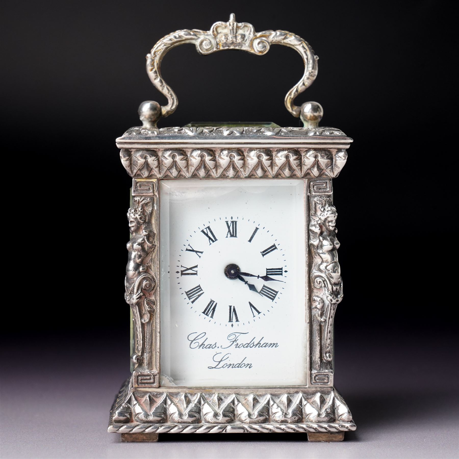 Chas Frodsham -  Miniature carriage clock with white dial and platform lever escapement in cast silver case with caryatid columns and bevelled glass panels H10cm  London assay No.0468