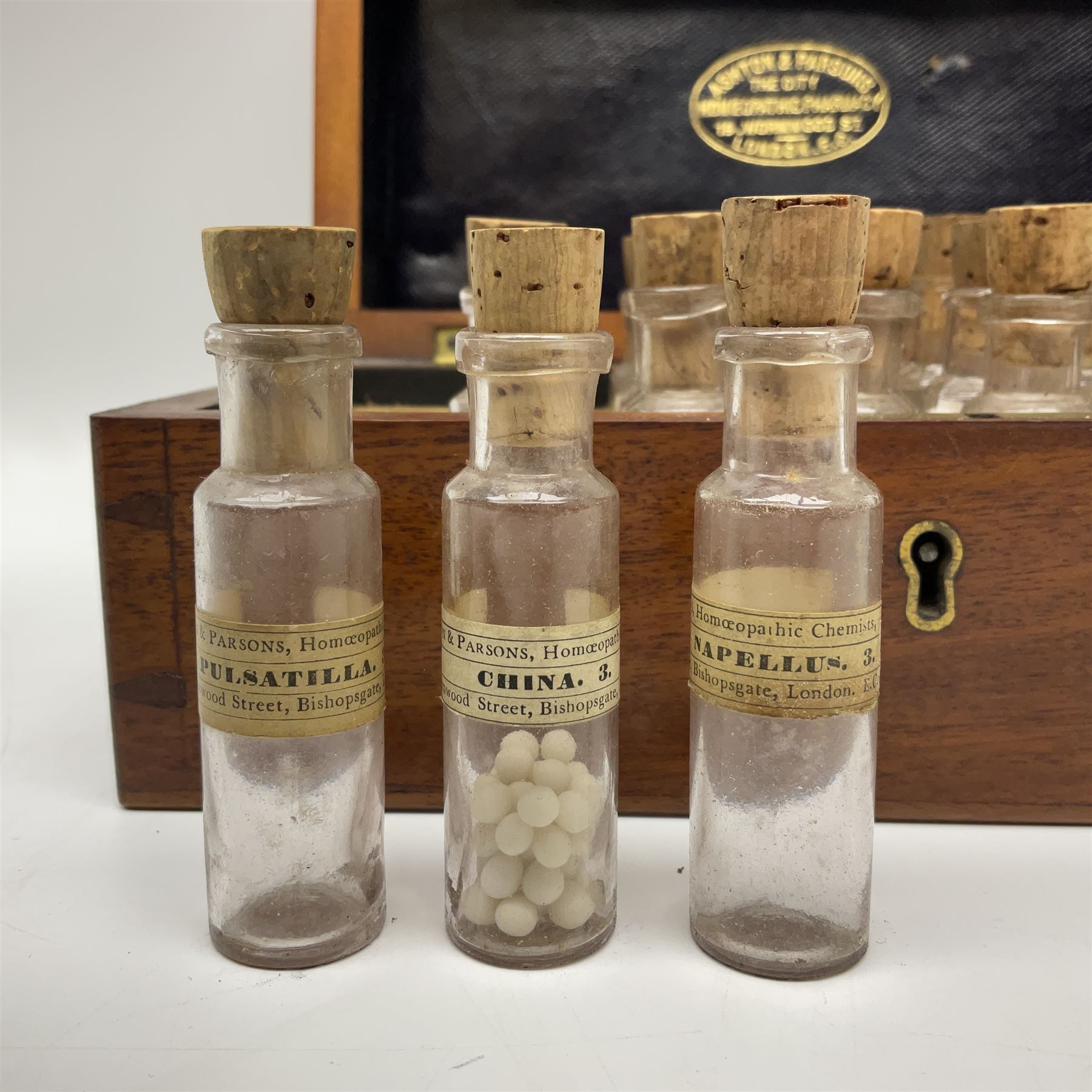 Ashton & Parsons Homeopathic pharmacy box, the fitted interior with thirty glass bottles with cork stoppers and labels to the glass, H10cm, L21cm