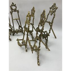 Nine ornate cast brass easel stands of various sizes, H24cm