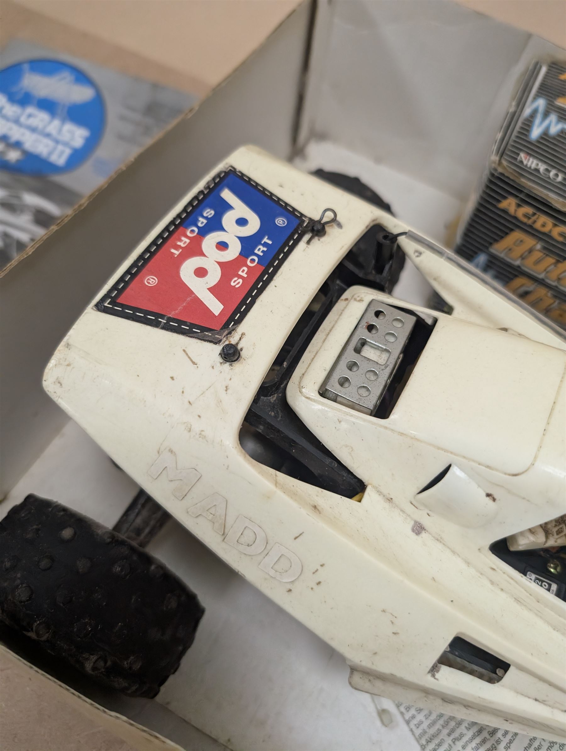 Tamiya 'The Grasshopper' 1:10 scale remote control car, boxed, together with an Acombs Techniplus-a controller, both boxed