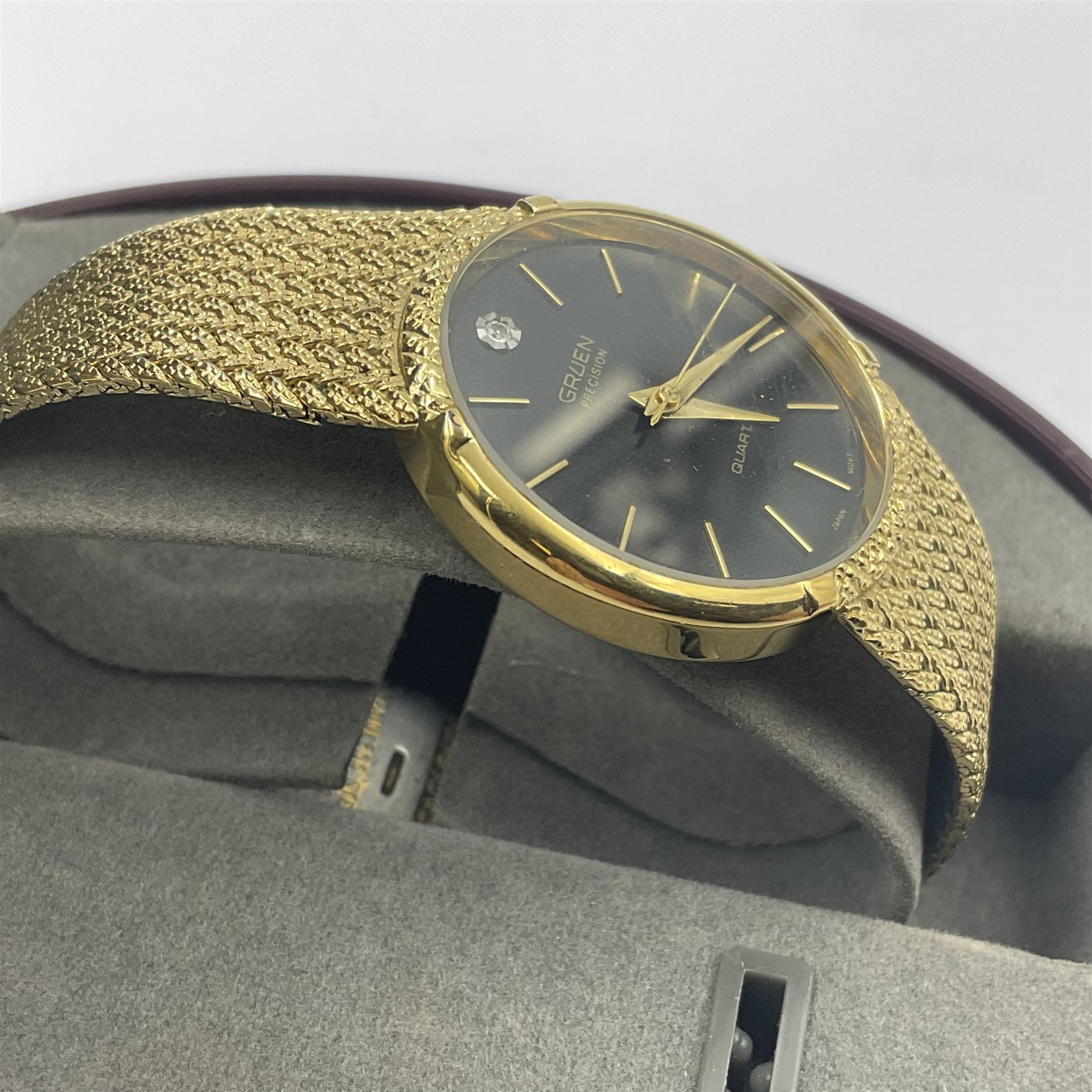 Gruen Precision gentleman's quartz wristwatch, with stone set black dial, on a stainless steel gilt metal strap, in original box