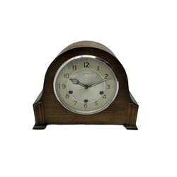 A 1930's Westminster chiming mantle clock in an oak case, with a two-piece silver effect dial, Arabic numerals and minute markers, within a chrome bezel fitted with a convex glass, 8-day triple train Smiths movement sounding the quarters and hours on gong rods, with strike /silent facility. With pendulum and key.



