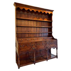 George III design cherry wood dresser, the projecting cornice over shaped frieze with pierced shell decoration, fitted with three shelves over six spice drawers, the base fitted with three long and two short drawers with cock-beaded facias, shaped and pierced apron over turned supports and panelled pot board base 