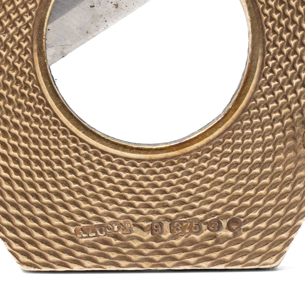 Asprey, 9ct gold hexagonal cigar cutter, hallmarked, with engine turned decoration  