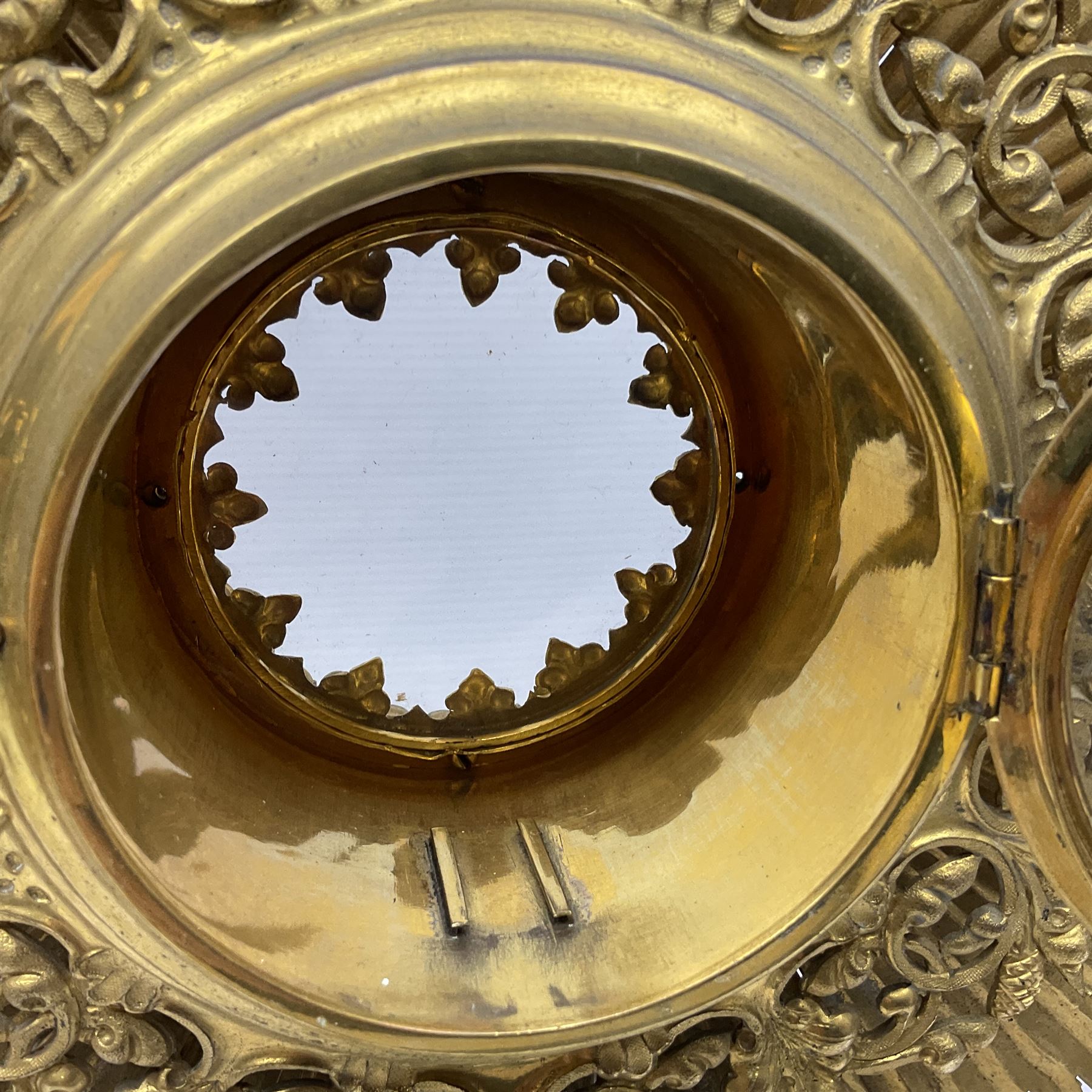 20th century gilt metal monstrance, in the Gothic revival style, with glazed aperture to centre surrounded with clear paste stones, in a pierced floral and scroll border set with coloured paste stones, within a sunburst surround, on a paste set knopped stem and similar foliate foot, H59.3cm