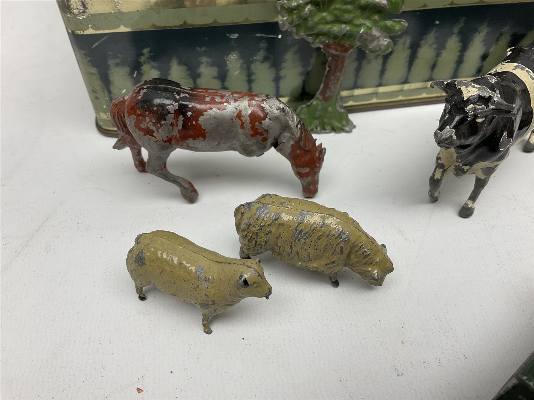 Chad Valley clockwork Fordson Major Tractor, a group of play worn Britains and other lead and metal farm animals, figures and accessories including a kennel, haystacks, dovecote, cows, sheep etc, together with a diecast model of a Tandem Bike L31cm