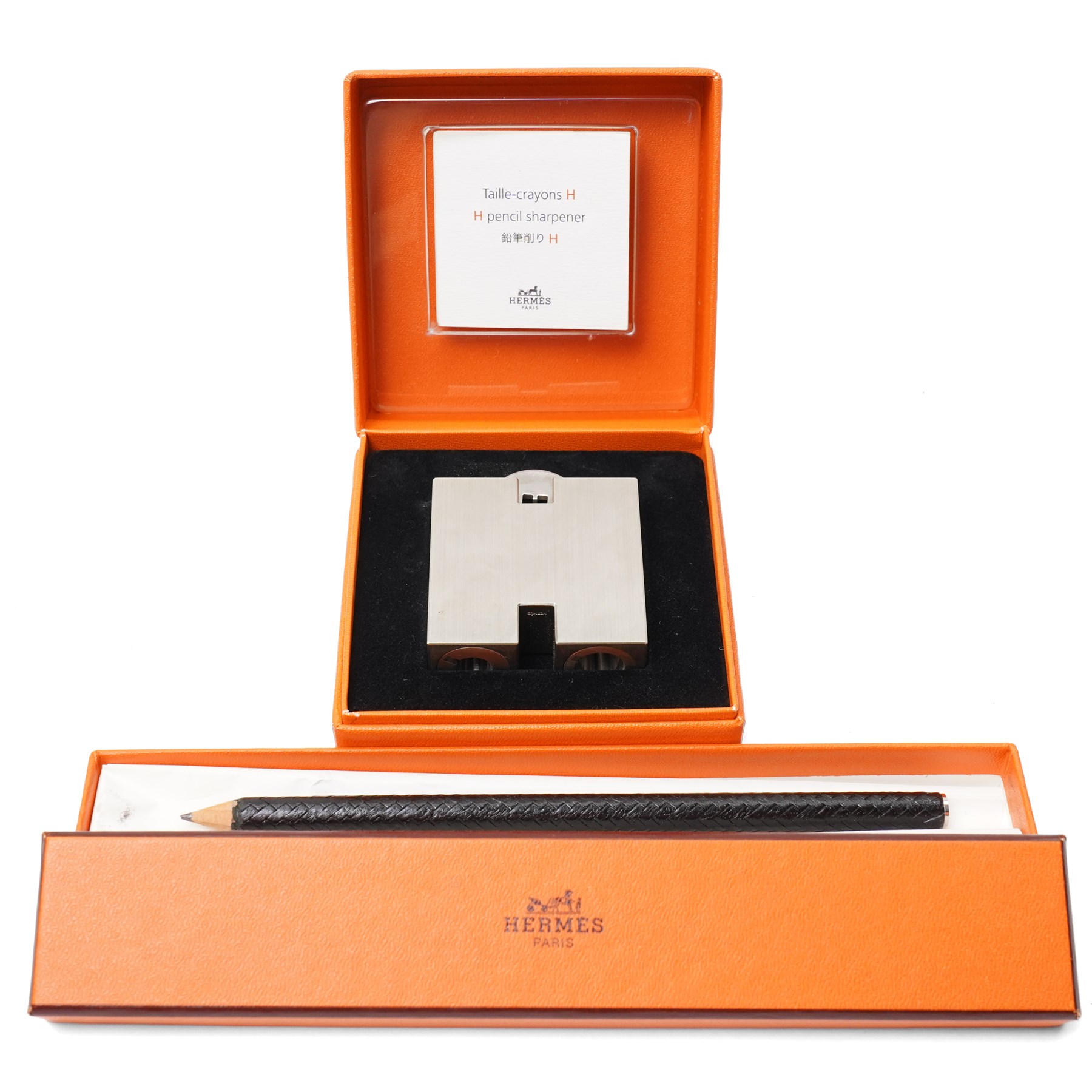 Hermès - ‘H’ pencil sharpener, brushed palladium-tone metal, with black leather-covered pencil, two original boxes and booklet