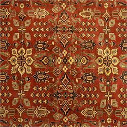 Afghan Gazni Kazak rug, the hand-knotted wool pile featuring a rust red ground with all-over geometric floral motifs in ivory and dark green, enclosed by a wide ivory border with stylised rosettes and angular vine decoration, fringed ends, from the region of Ghazni, Afghanistan