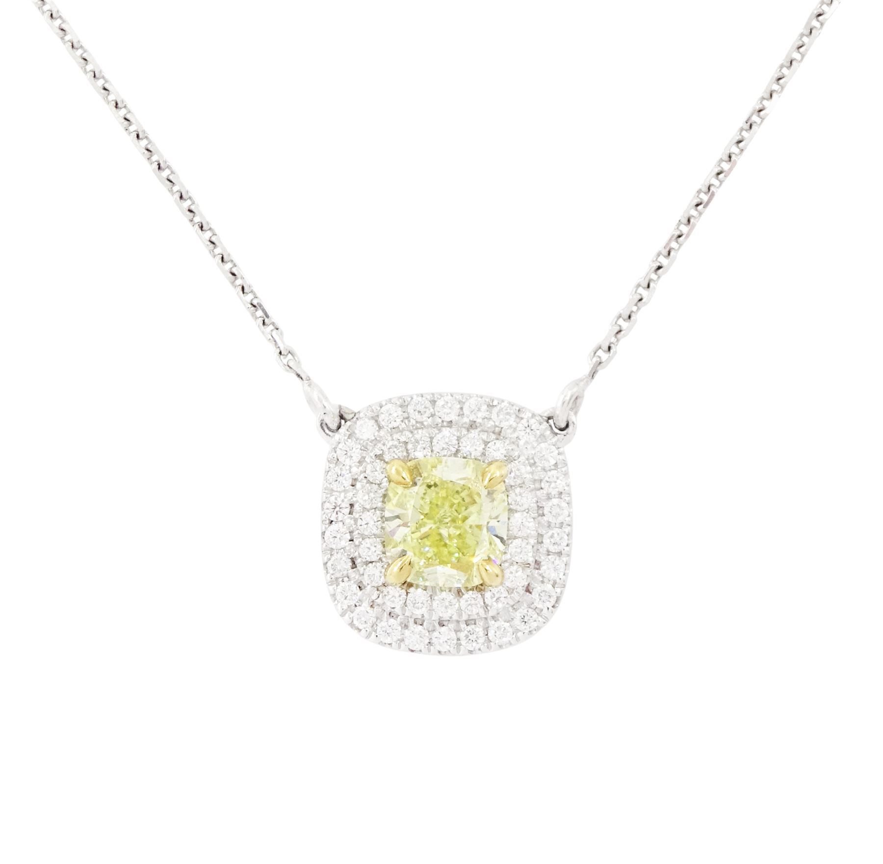 18ct white gold diamond pendant necklace, single cushion cut fancy yellow diamond of 1.05 carat, surrounded by a double halo of round brilliant cut white diamonds, to a fine trace link chain necklace, hallmarked, total white diamond weight 0.26 carat 
