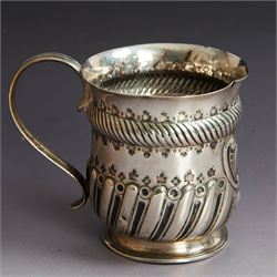Victorian silver christening mug, of circular form with C scroll handle, embossed with scrolls and foliate decoration, with vacant oval cartouche to body, hallmarked John Aldwinckle & Thomas Slater, London 1890, contained within a tooled leather fitted case, mug H8cm