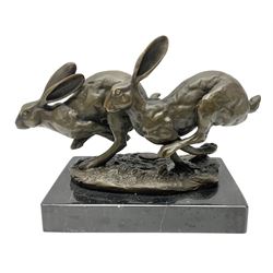 Bronze figure group, modelled as two hares in chase, upon a naturalistic base signed Nick and with foundry mark, raised upon a rectangular marble base, overall H12cm. 