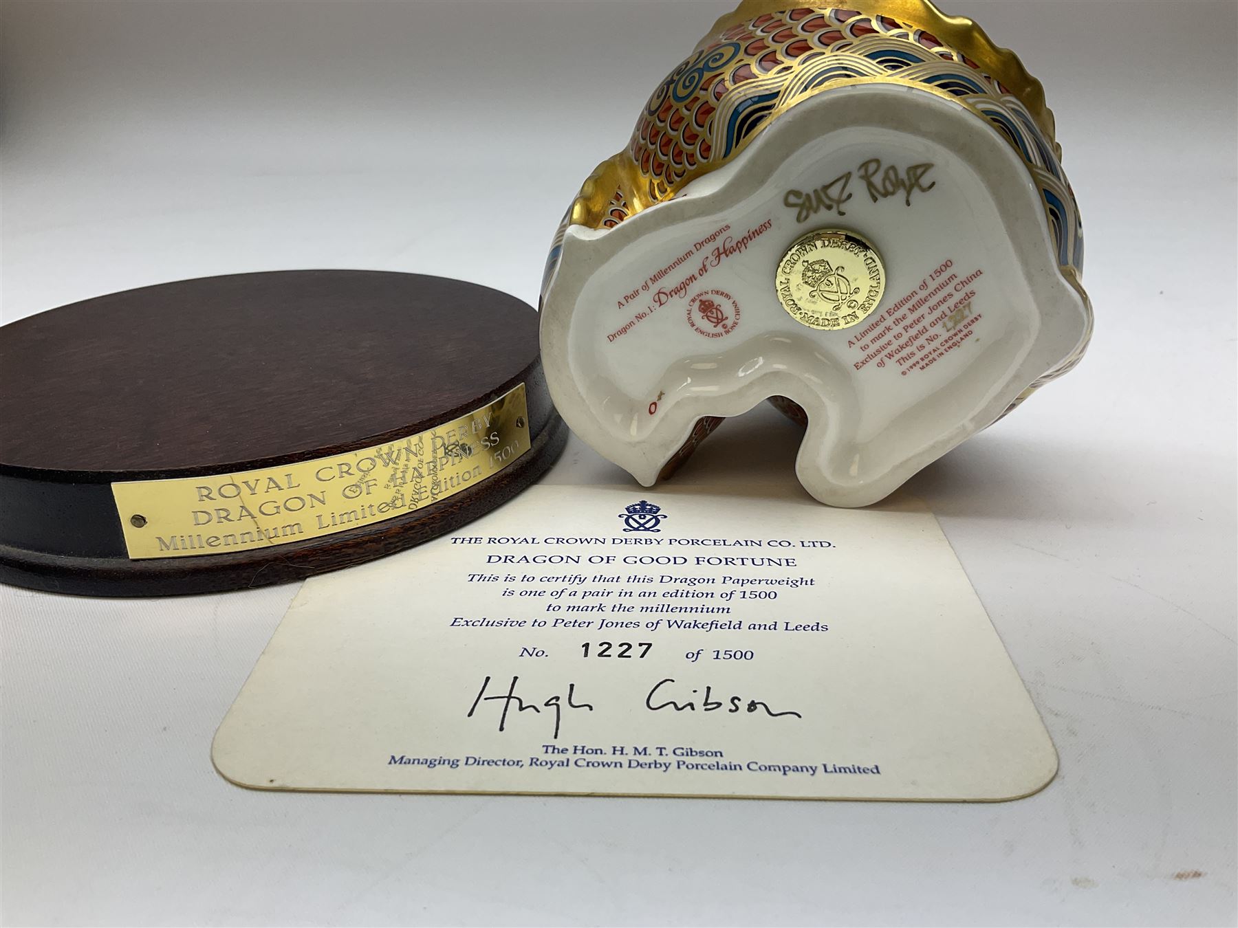 Two Royal Crown Derby paperweights, Dragon of Happiness, limited edition 1227/1500 and Dragon of Good Fortune, limited edition 1227/1500, both with gold stopper, hardwood base, certificate and with printed mark beneath