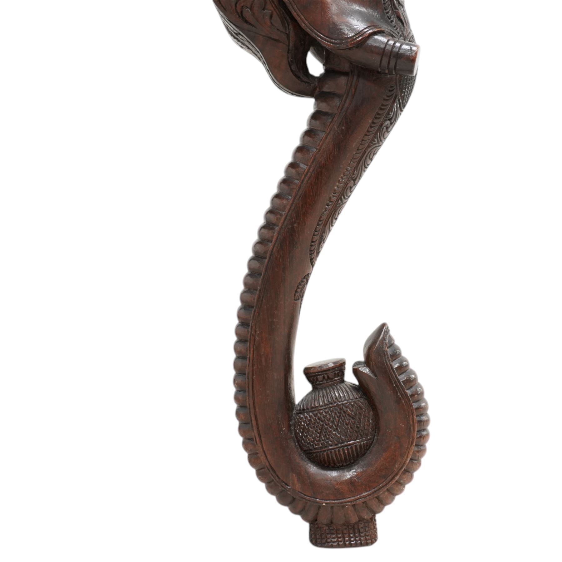 Anglo-Indian hardwood occasional table, circular top carved with concentric pattern and scrolling foliage, on three elephant carved supports decorated with flower heads