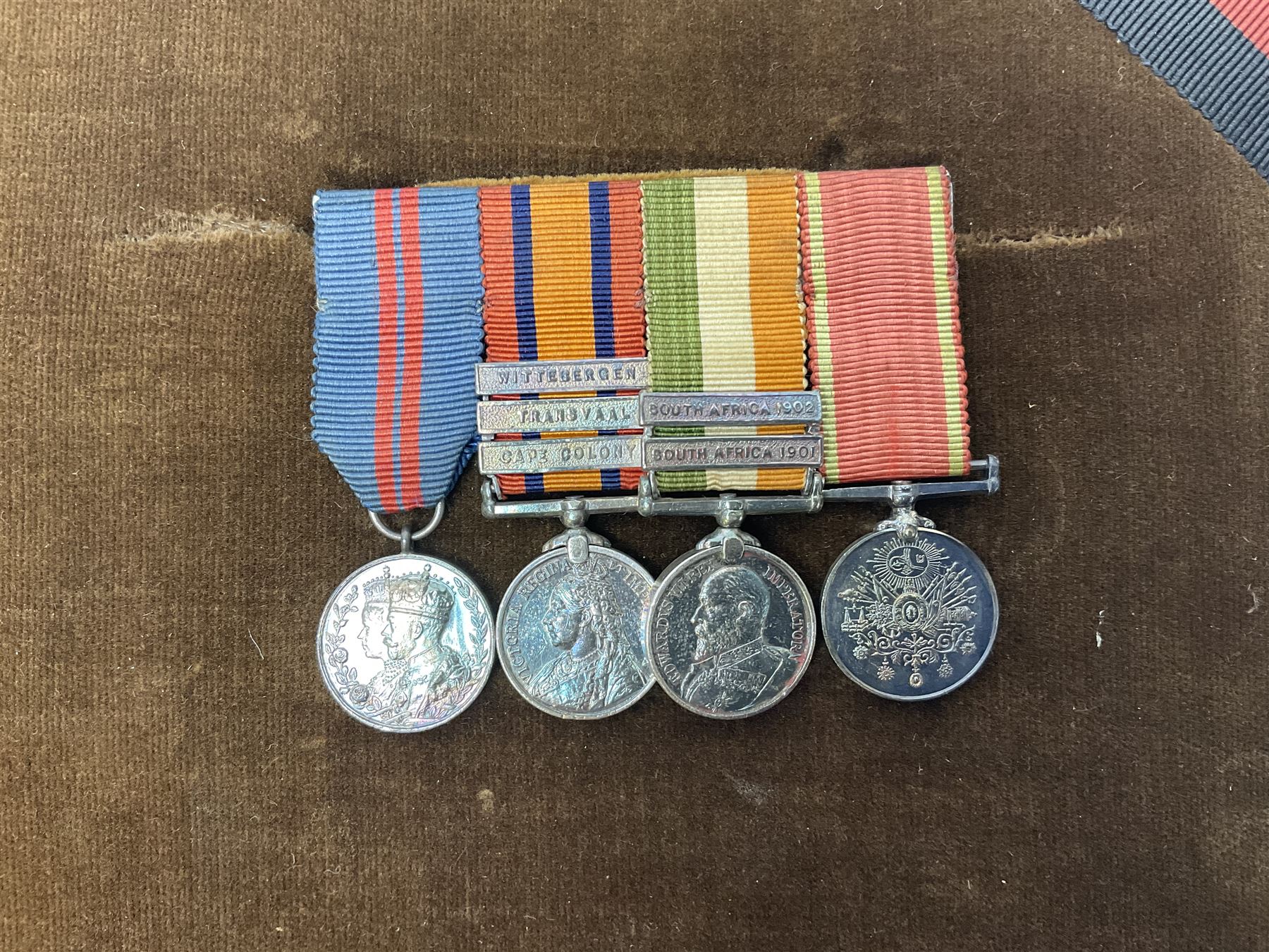 DOW Eure-et-Loir group of seven Boer War/WW1 medals comprising Queens South Africa Medal with three clasps for Cape Colony, Transvaal and Wittebergen, Kings South Africa Medal with two clasps for South Africa 1901 and South Africa 1902, Turkish Liakat Medal, George V Coronation Medal, 1914 Star with 5th Aug.-22nd Nov. 1914 bar, British War Medal and Victory Medal awarded to Captain Douglas Leslie Stephen Grenadier Guards; group of four Boer War and 1911 Coronation miniature medals; all with ribbons and later mounted and framed with his bronze memorial plaque;  together with Cecil Cutler (active 1886-1934) heightened watercolour three-quarter length portrait of Douglas in uniform, signed and dated 1915, 52 x 35cm; gilt frame; Auctioneers Note: Douglas was the elder brother of Albert Alexander Leslie Stephen (see previous lot) and died of wounds on 10th September 1914 in France.