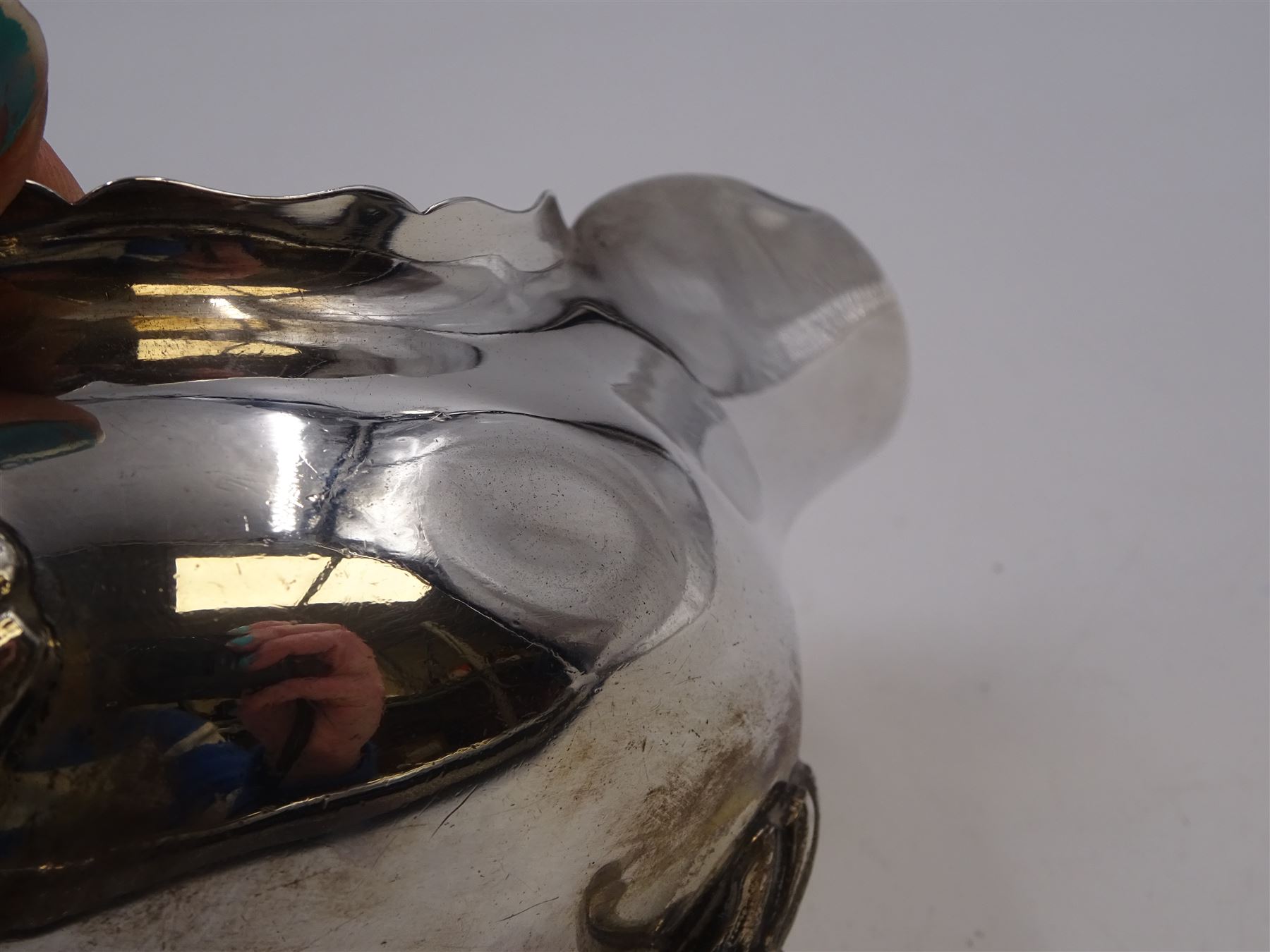 Pair of silver sauce boats, of typical plain form, with acanthus capped flying scroll handle and each upon three hoof feet, hallmarked Walker & Hall, Birmingham 1901, H9cm