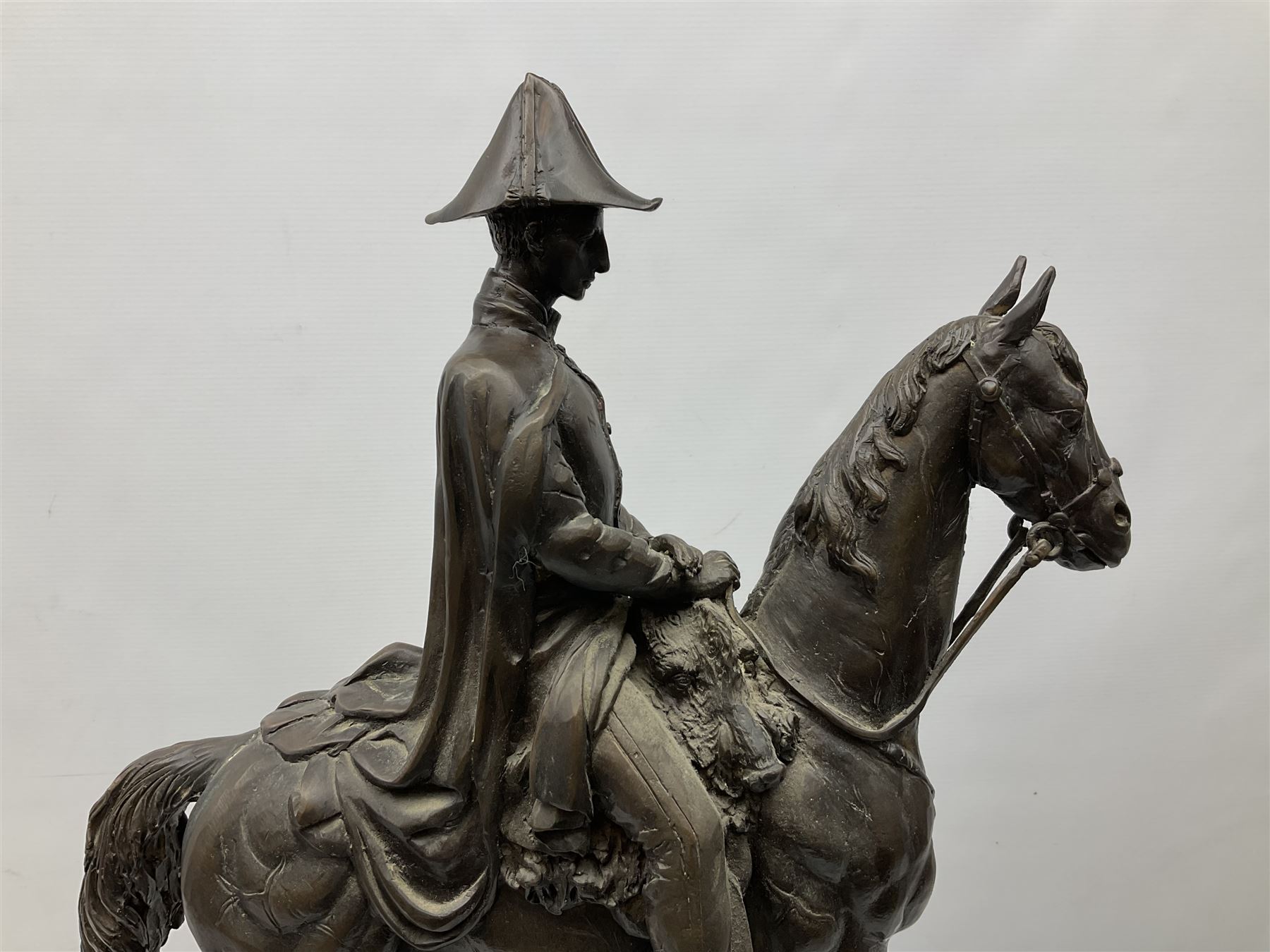 Large and impressive bronze figure of Wellington seated on a horse, on a sarcophogus shaped stepped base impressed 'Meunier Paris', the canted corners inset with battle trophies H68cm L50cm D22cm