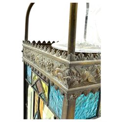 20th century Gothic design stained glass and brass hall lantern, with ornately decorated frieze and apron, with geometric coloured glass panels and eight rectangular bevelled glass panels, with bell shade, wired for electricity 