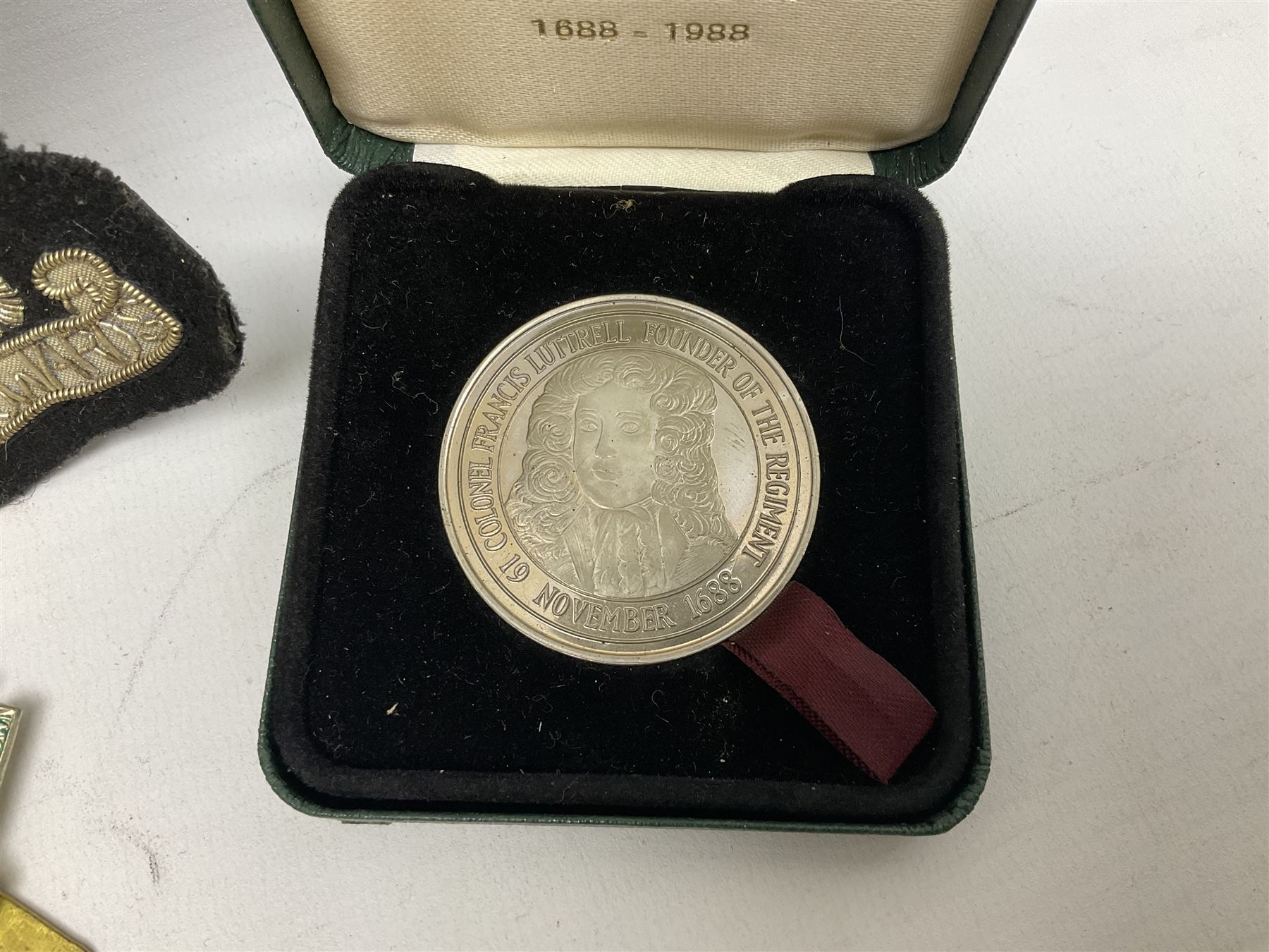 Limited edition Spode Green Howard's twin handled loving mug, no 205/300, with certificates, together with a Green Howards cased Tercentenary medal (1688-1988), cap badge and embroidered patch, largest H11.5cm