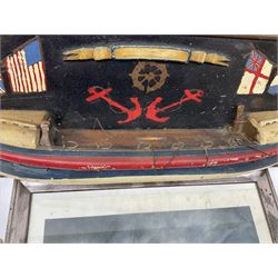 RNLI collection box in the form of a boat makers half block model, painted in the colours of a lifeboat with flag and ship motifs, H25cm, L73cm together with framed photos, postcards and prints of lifeboats and crew, including Scarborough lifeboat station