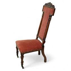 Victorian walnut high back hall chair, with pierced and scrolled crested rail above a rectangular back and seat upholstered in plush cerise fabric, flanked by tulip carved and turned uprights raised on turned and tapered front legs  