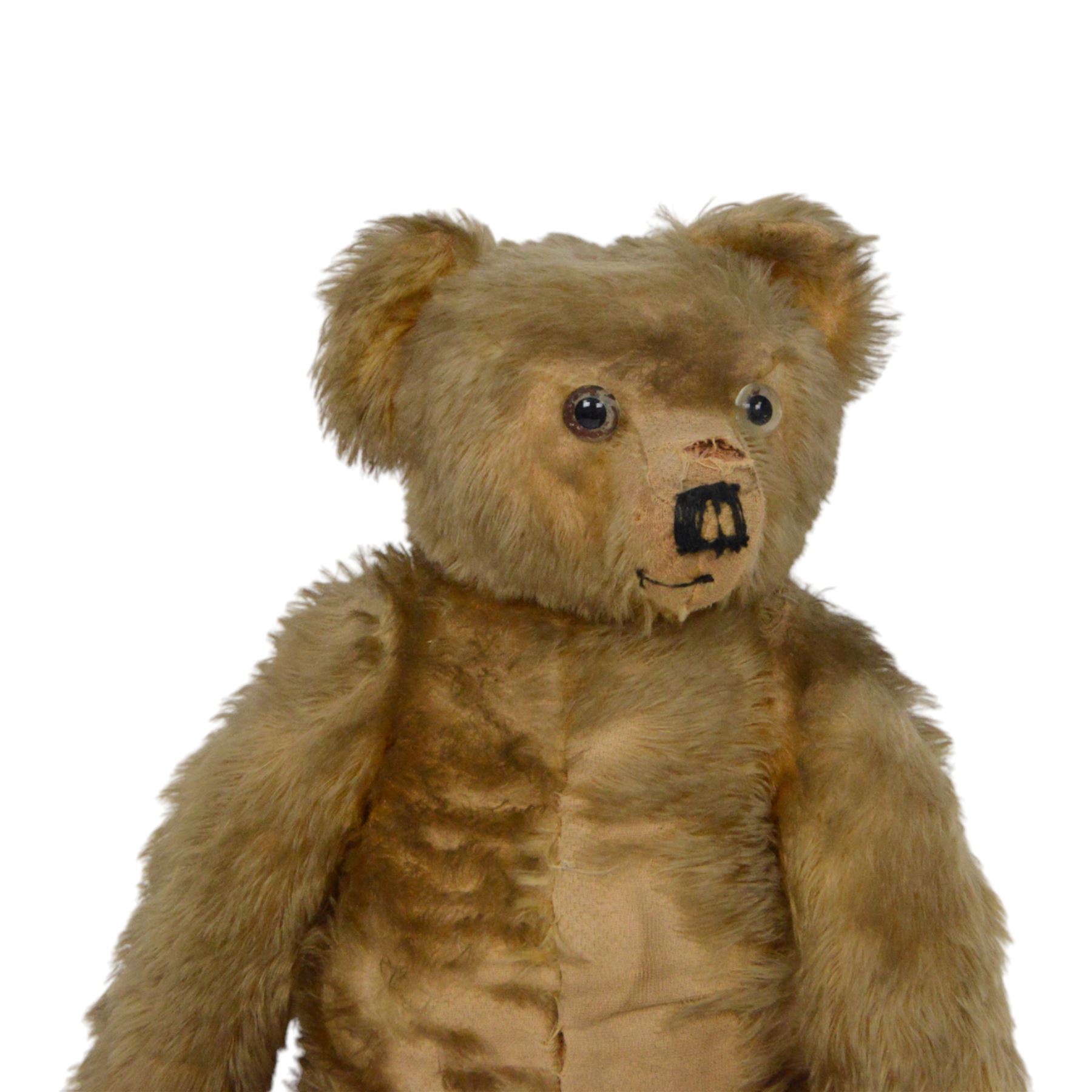 Early 20th century teddy bear, probably German, blonde mohair bear with glass eyes, straw filled snout with stitched nose, hand stitched centre seam, wood wool filled body, jointed limbs, swivel head and hump to back, H67cm