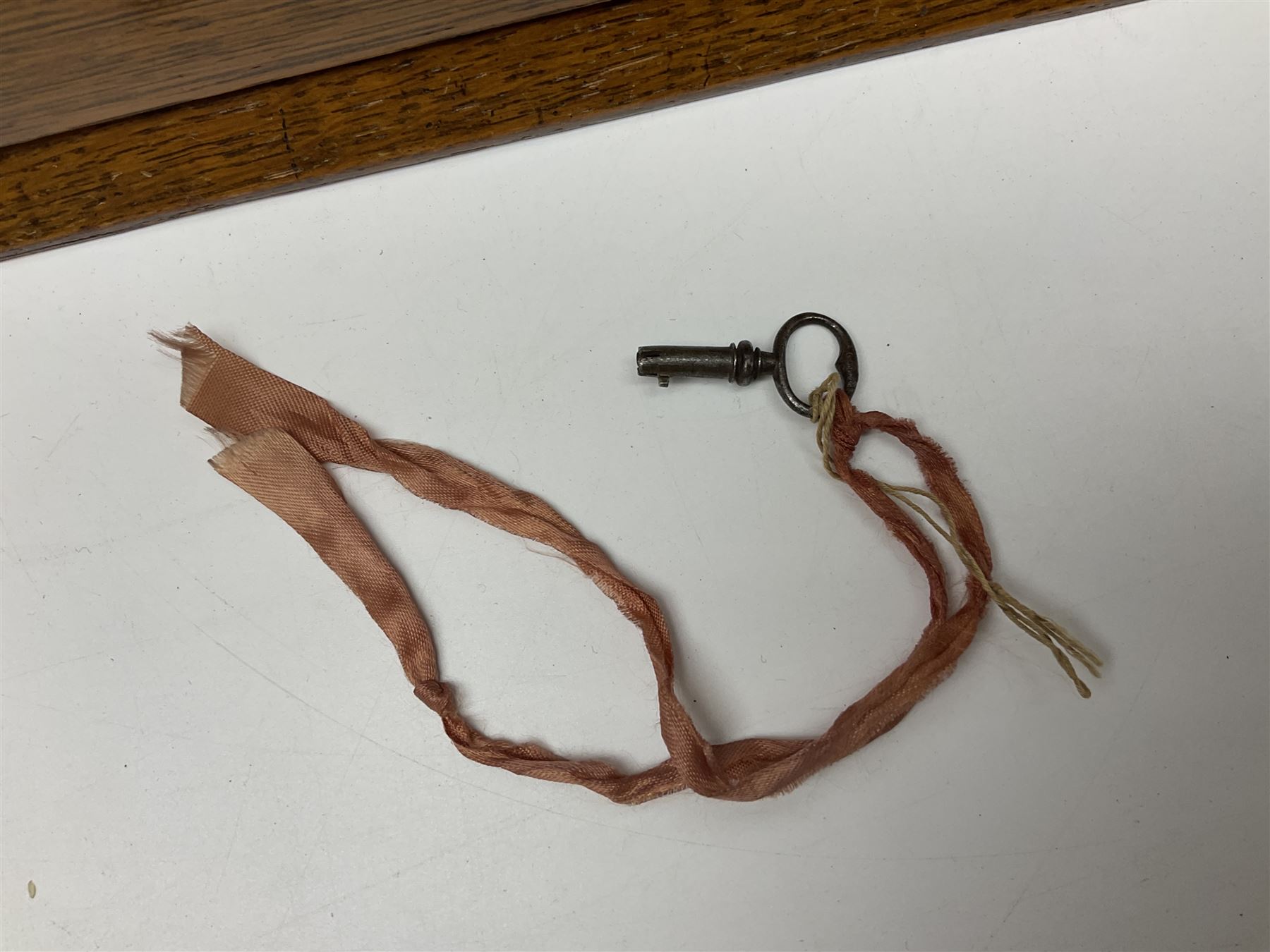 Victorian oak tantalus, mirrored high-back with recess for housing the decanters, behind a hinged box, with cribbage board to the concealed drawer below, marked Barman, London, H33cm, L37cm