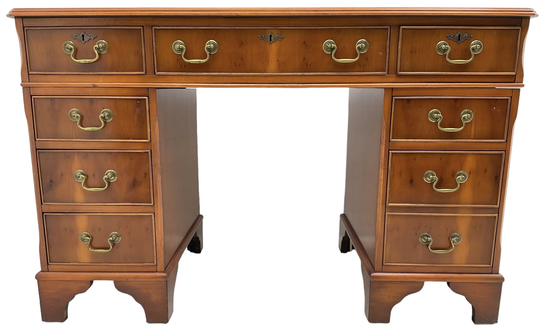 Georgian design yew wood twin pedestal desk, rectangular top with green leather inset writing surface, fitted with nine cock-beaded drawers, on bracket feet