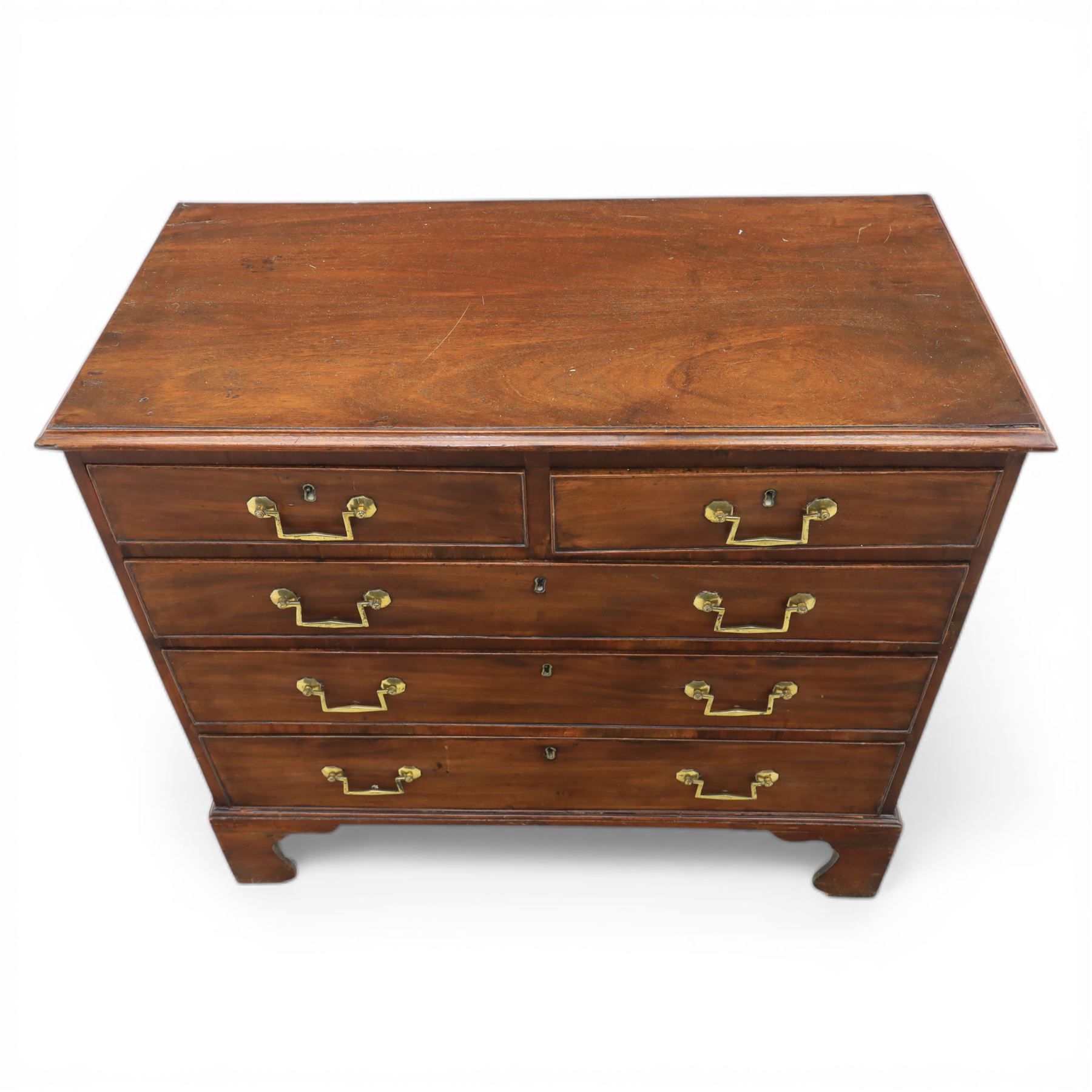 Small late Georgian mahogany chest, rectangular moulded top, above two short and three graduating long drawers, finished with square swan neck handles, raised on ogee bracket feet 
