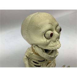 Cast iron mechanical money box in the form of a skeleton, H16cm