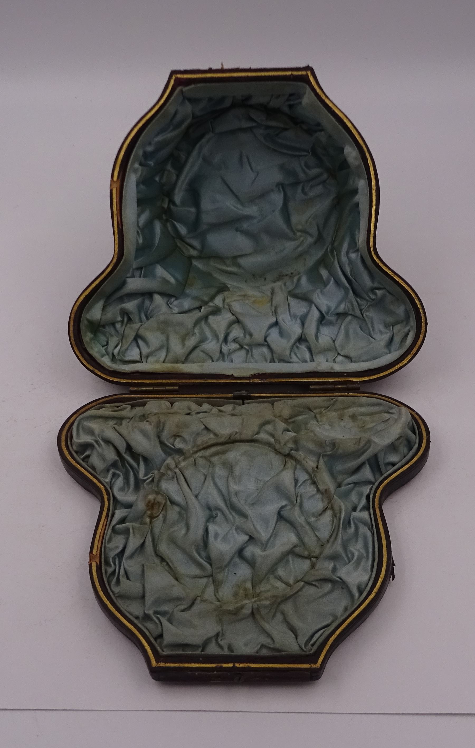 Victorian silver bowl, with embossed floral decoration and beaded rim, gilt interior and two applied shield cartouches, upon stepped circular foot, with a silver apostle spoon, with gilt bowl, both hallmarked George Unite, Birmingham 1883, bowl H5.5cm, within fitted tooled leather, silk lined case