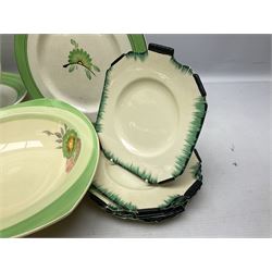 Clarice Cliff for Newport Pottery Corolla pattern tea and dinner wares, comprising triangular bowl, four side plates, two shallow bowls and teacup (a/f), together with a Clarice Cliff Wilkinson twin handled soup bowl and unassociated saucer both decorated with pink and yellow flowers, together with other mid century ceramics comprising Parrott and Company Coronet Ware, and Royal Staffordshire AJ. Wilkinson Ltd dinner wares