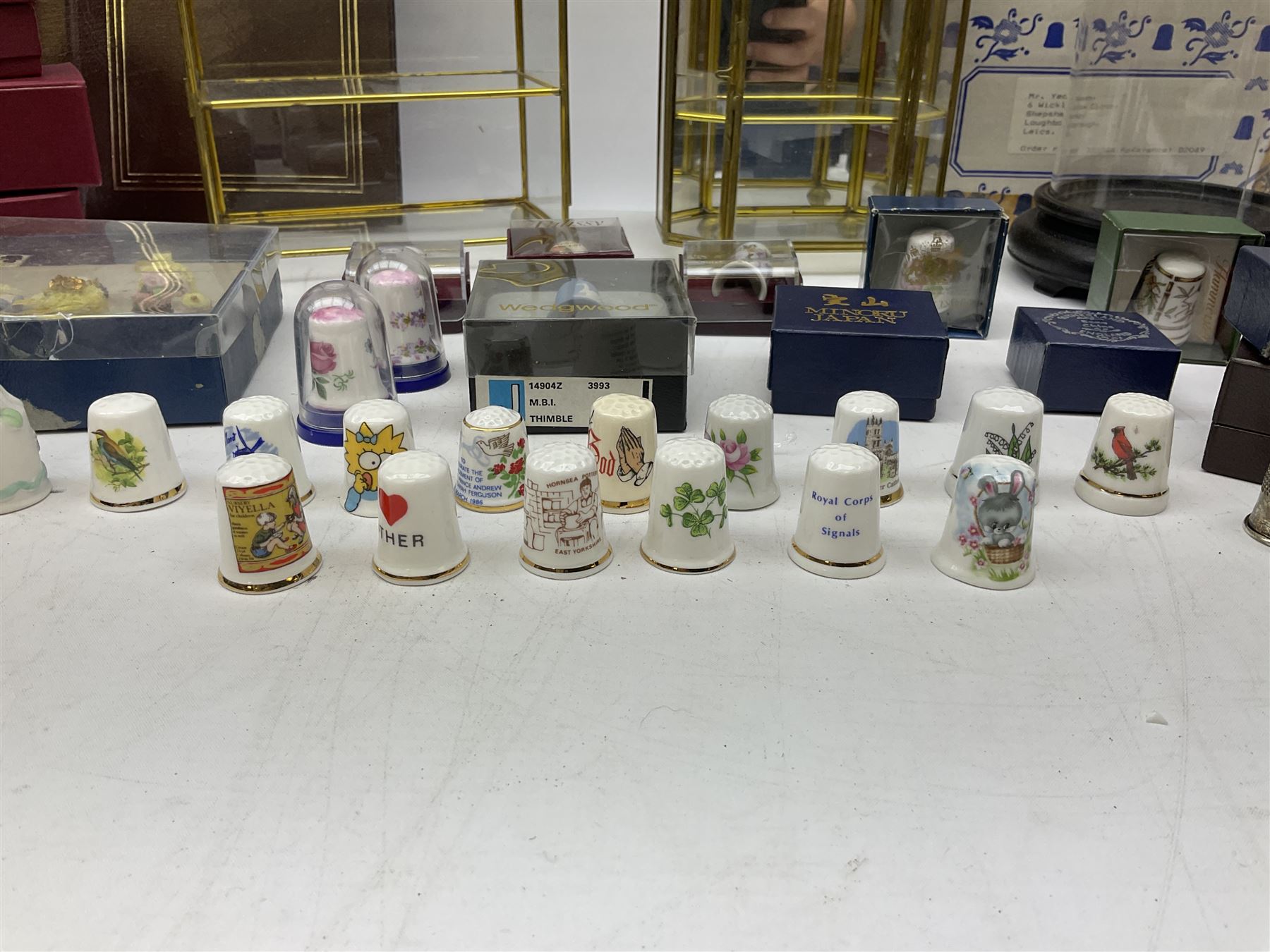 Quantity of thimbles to include twelve Irish Dresden lace examples, Royal Crown Derby, Spode, Portmeirion, Wedgwood, Royal Grafton etc, together with three display cases, many with certificates