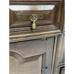 18th century oak dresser base, rectangular two plank top over drawers and cupboards, the drawer fronts mounted with geometric faceted panels with applied mouldings, the cupboards enclosed by doors with stepped arch fielded panels, on stile supports, W209cm, H85cm, D55cm