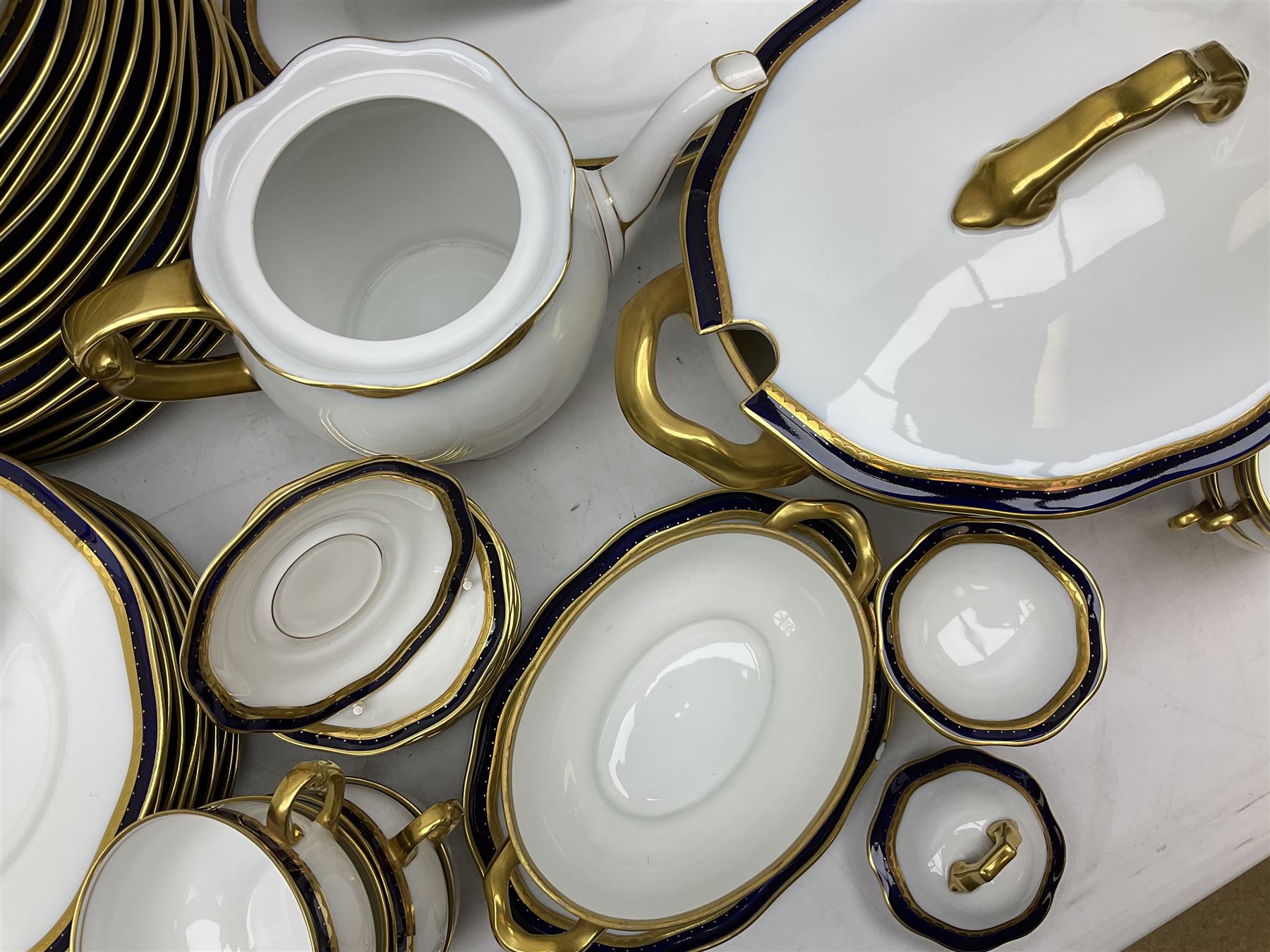Pirkenhammer of Czechoslovakia Carlsbad pattern tea and dinner for twelve place settings to include dinner plates, soup bowls, side plates, covered tureen, tea cups and saucers, coffee cups and saucers, teapot, milk jug, covered surier, etc, with an addition twelve dinner plates (110)