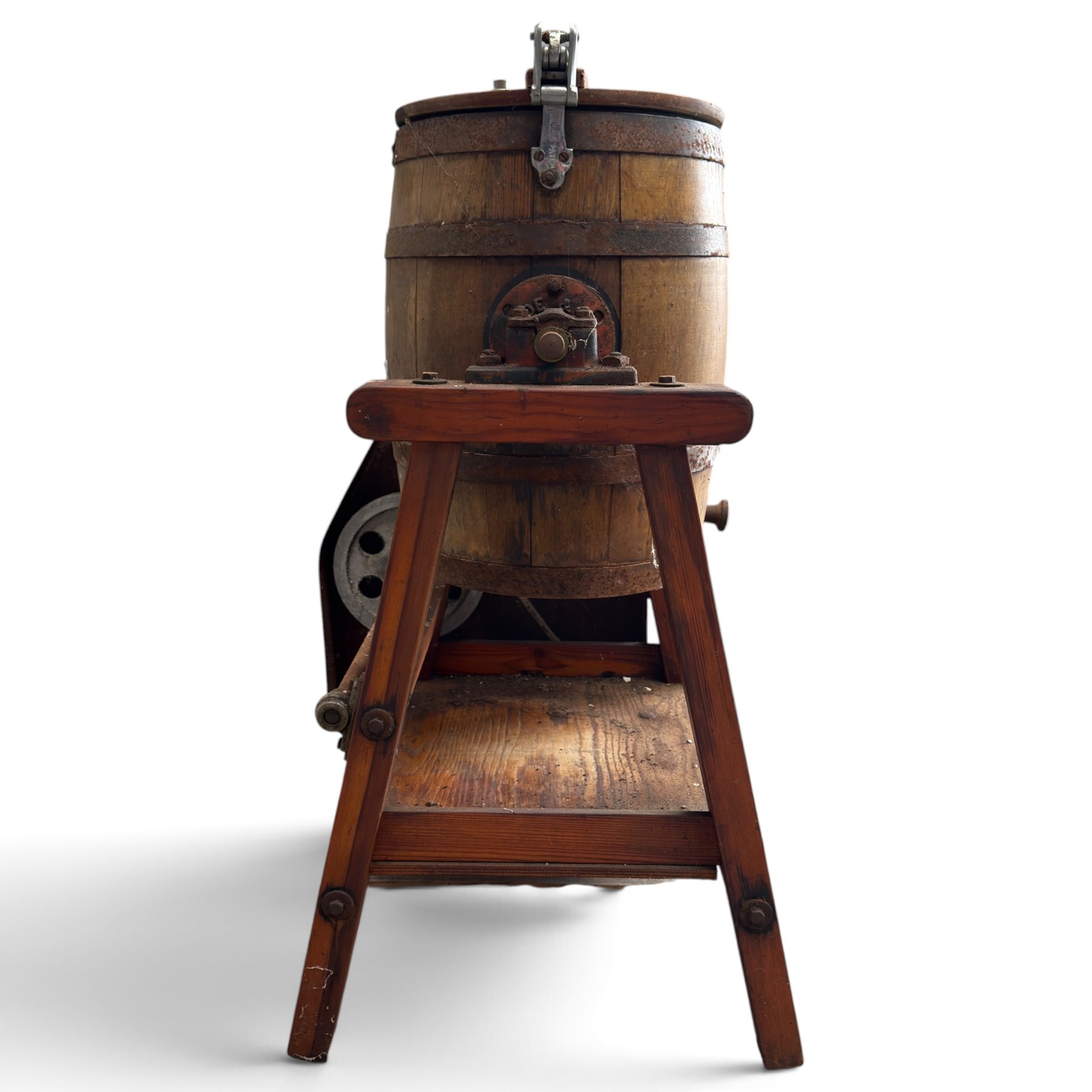Two early 20th century dairy equipment items: Waide & Sons, Leeds – oak barrel butter churn with iron bands, later converted to electric operation, on trestle stand (W71cm H115cm); Lister – ‘Ball Bearing’ cast iron cream separator, with hopper and foot pedal, in red-painted finish (W47cm H49cm)