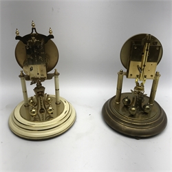 Late 20th century Kundo anniversary clock, Arabic dial, cream painted and decorated with flowers and another late 20th century anniversary clock with black dial, both under glass domes